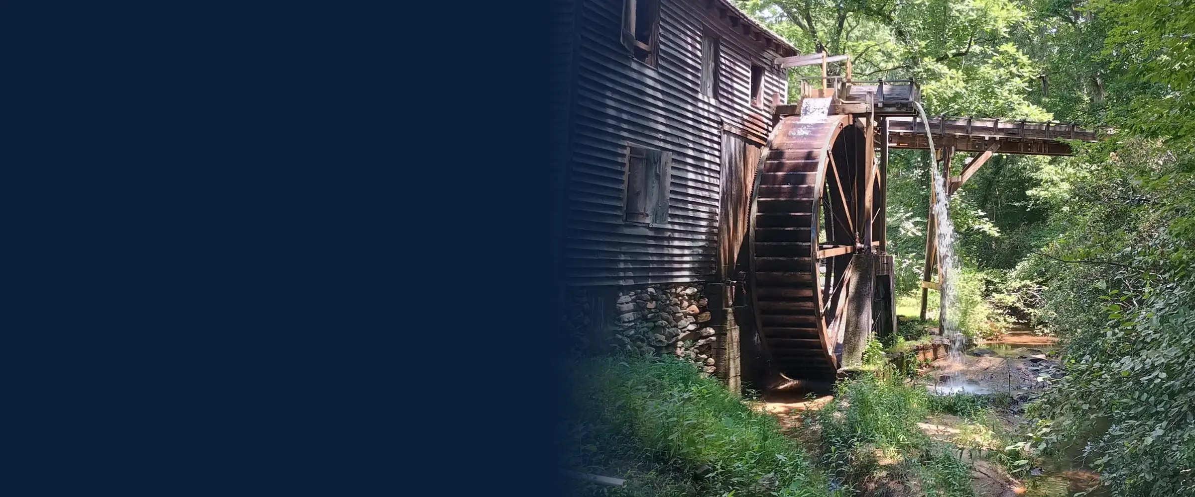 Historic water mill with a wooden waterwheel